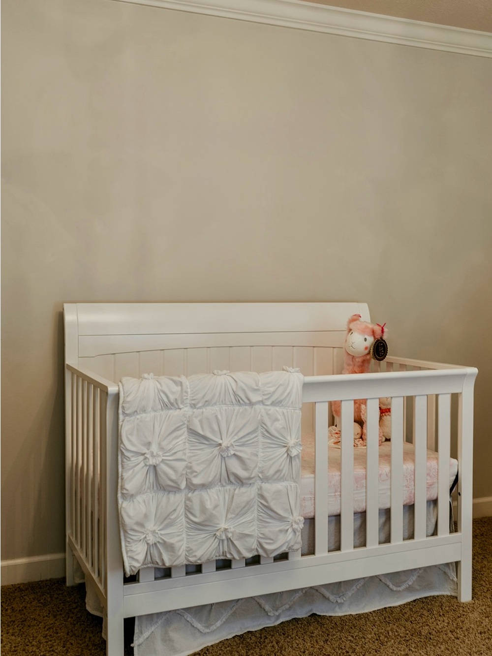 Anthropologie white crib skirt for traditional sized crib.